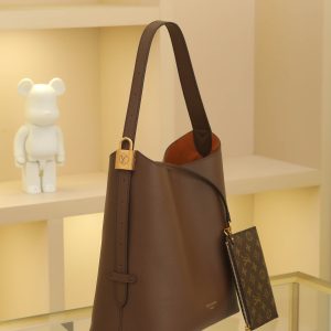 Alternative view of Chocolate Brown Low Key Hobo Medium Handbag Crafted from supple cowhide leather with clean, understated lines, this piece features a velvety suede lining that exudes contemporary flair, showcasing the brand's masterful craftsmanship. An adjustable shoulder strap is adorned with a signature monogrammed padlock, while ample interior space effortlessly accommodates daily essentials like a laptop. Dimensions: 31.0 x 35.0 x 18.0 cm